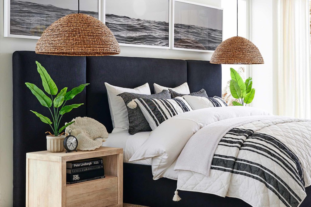 A white bed and a gray headboard in a pretty bedroom 