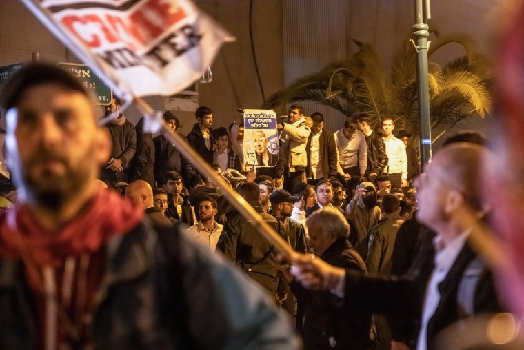 Orthodox youth holds a placard with Prime Minister Benjamin