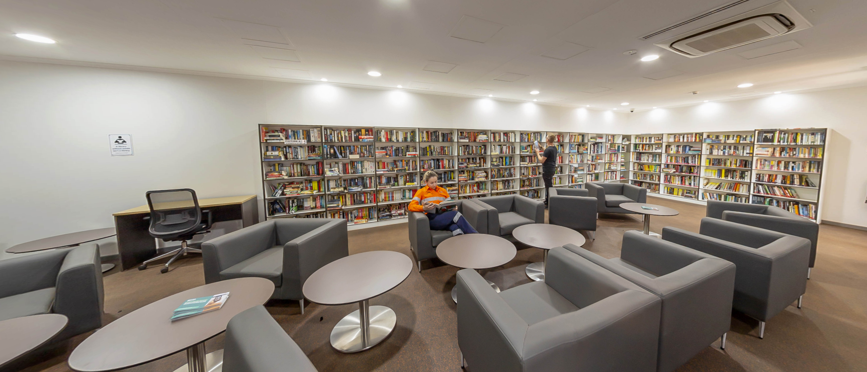 A worker reading inside the 3000-book library